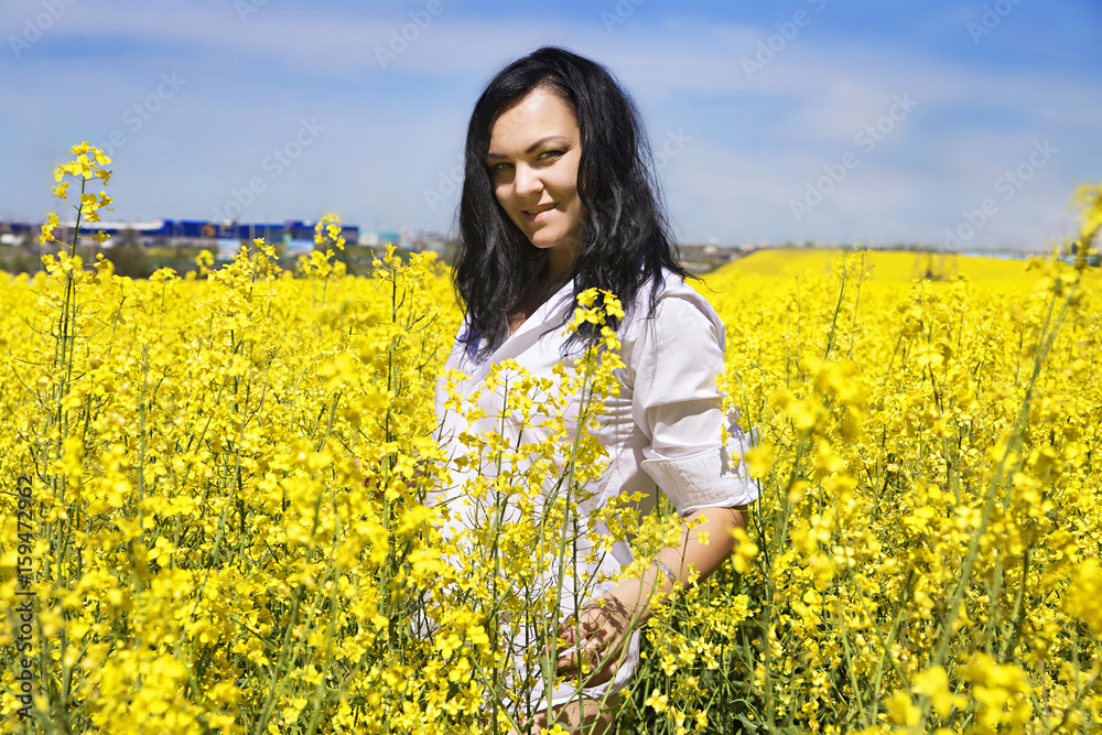 girl in white shirt at the yellow flower field girl in white shirt at the yellow flower field
