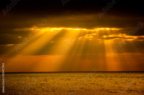 Sun breaks through the clouds in Santiago de Cuba and,lights up your hope. photo