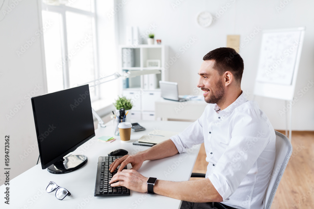 businessman typing on computer keyboard at office