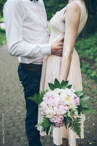 man and woman with bouquet close up