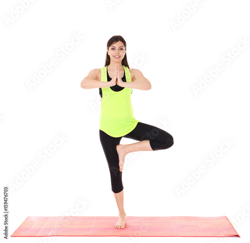 Young beautiful pregnant woman doing yoga exercise isolated on white