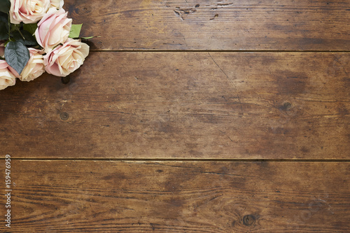 Roses on rustic wood background