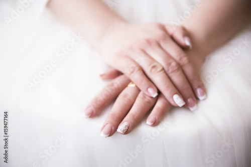 bride hand on white dress ready for marriage ceremony