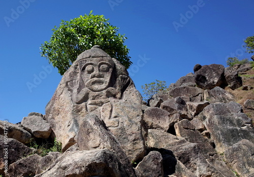 An ancient rock carving looks out over the valley near San Agustin archaeological park Colombia