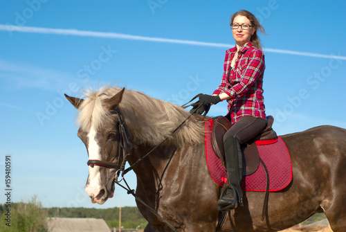 Serios women on horseback.