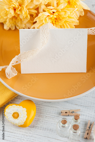 Chrisanthemum flowers on a plate on a wooden table photo