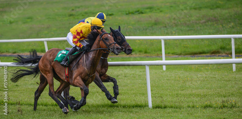 Two jockeys and race horses battling for position in the race   © Gabriel Cassan