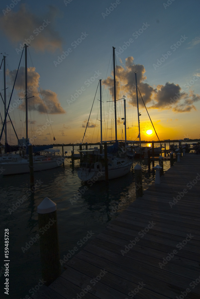 sunrise over the marina with docked sailboats