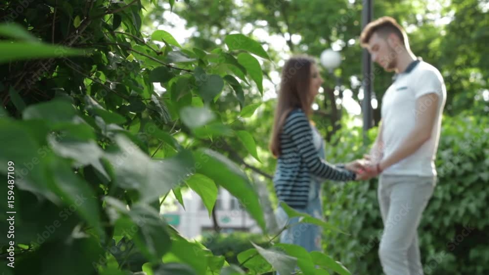 loving couple in the Park holding hands and talking loving couple in the Park holding hands and talking
