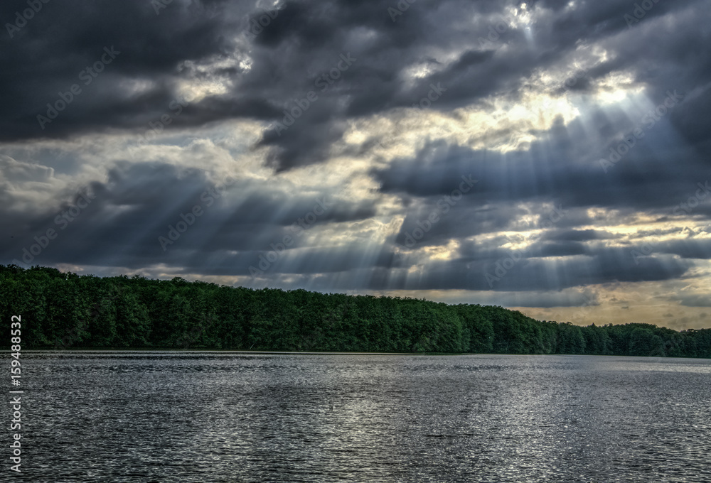 sun through clouds and pond