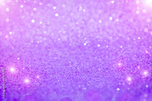 Bright and abstract blurred purple bokeh background with shimmering glitter