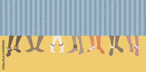 Barefoot on the beach. Set of feet of men and women behind a bath towel.