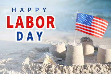 Sand castle with American flag on beach