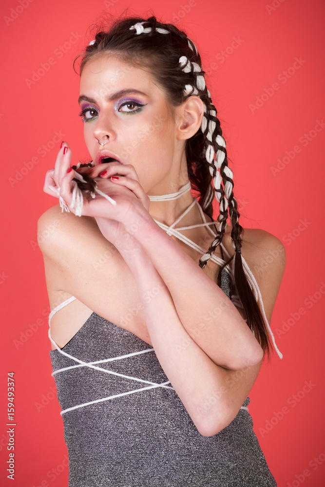 Obraz premium woman with stylish braids and nose ring licking fingers