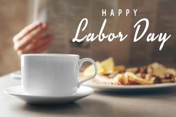 Cup of fresh hot coffee and breakfast on table, closeup