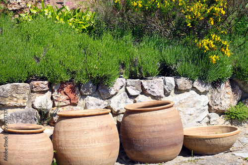 Clay pots near stone wall