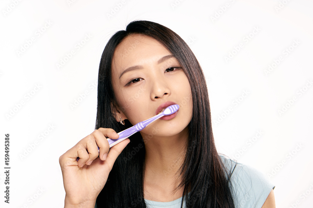 Oral care, woman brushes teeth on isolated background Oral care, woman brushes teeth on isolated background