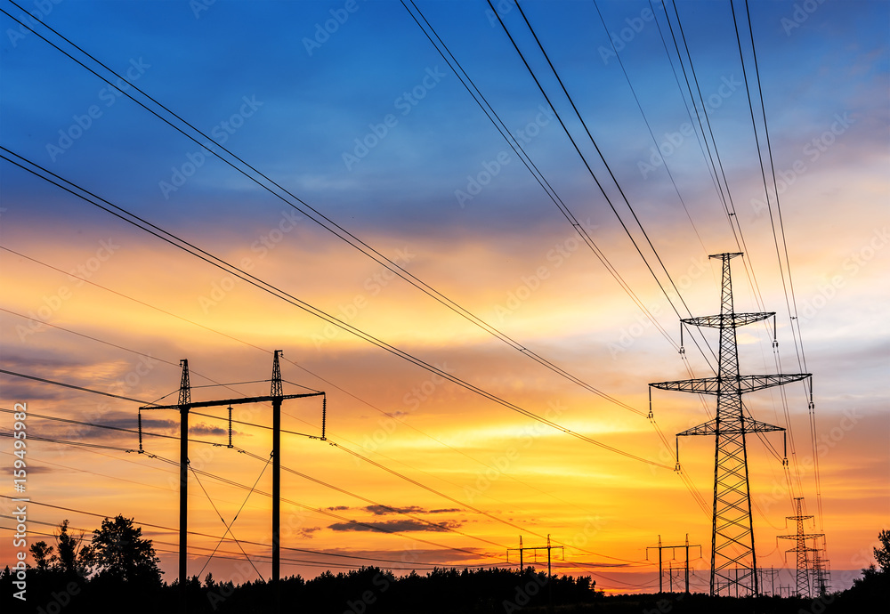 high-voltage power lines at sunset.