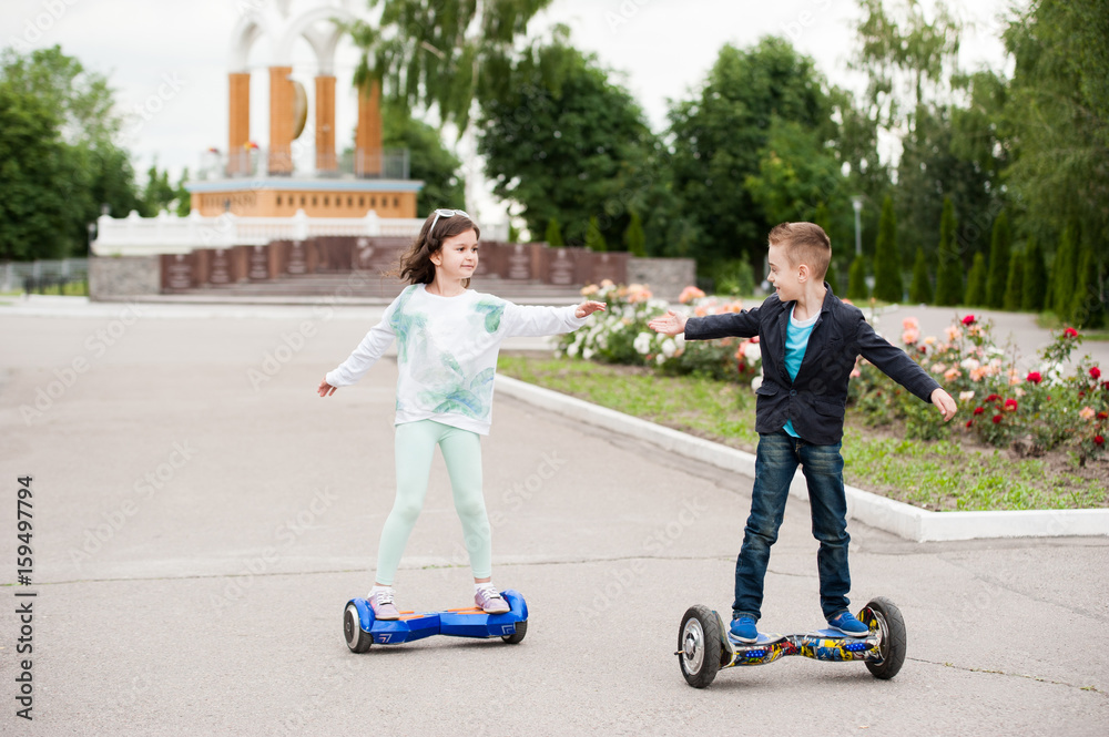 little boy and girl ride on mini segway little boy and girl ride on mini segway
