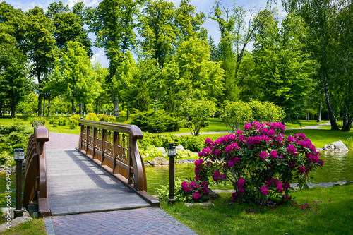 Landscaping in the garden. The path in the garden.Beautiful backyard landscape design Some flowers and nicely trimmed bushes on the leveled front yard Landscape formal