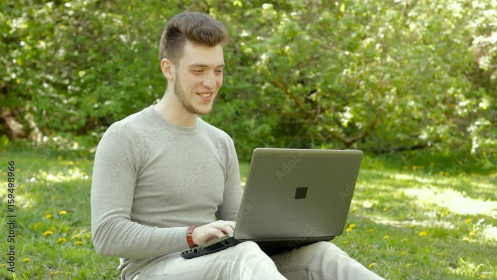 happy young boy laughing and working with laptop happy young boy laughing and working with laptop
