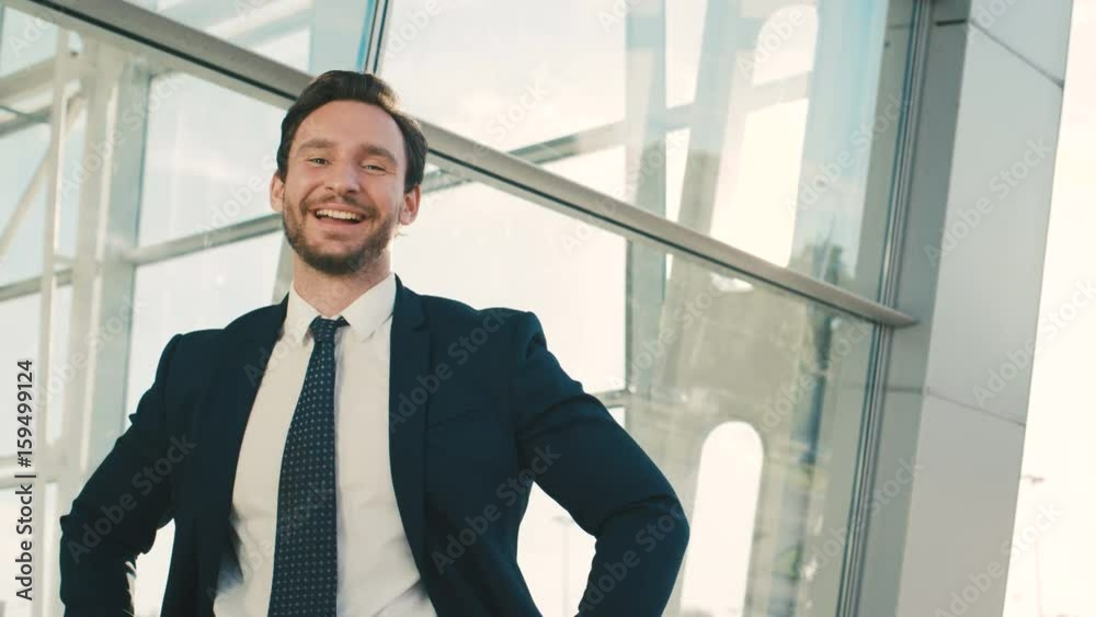 Happy attractive businessman showing different emitions. Happy, fynny emotions. Outdoors near office windows. close up Happy attractive businessman showing different emitions. Happy, fynny emotions. Outdoors near office windows. close up