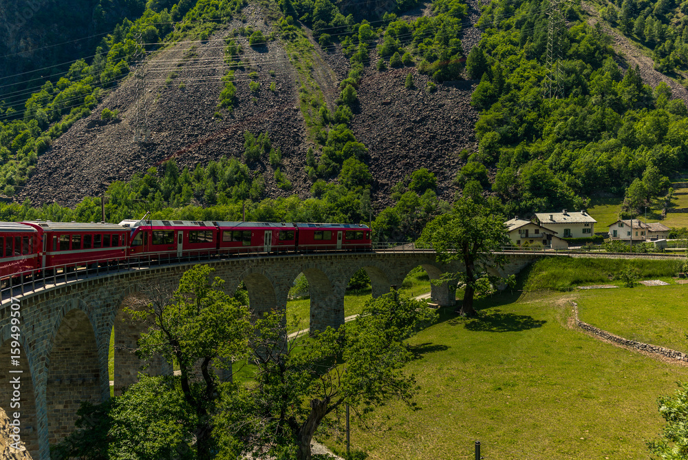 Train on the circular viaduct bridge near Brusio on the Swiss Alps - 3