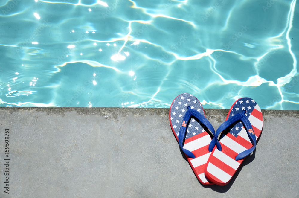 Naklejka premium Summer background with flip flops near the pool