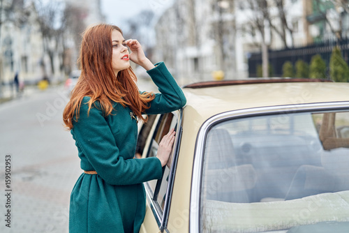 A woman stands by the car, a woman leans on a car © SHOTPRIME STUDIO