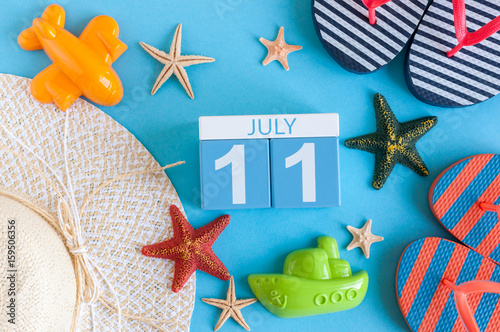 July 11th. Image of july 11 calendar with summer beach accessories and traveler outfit on background. Summer day, Vacation concept photo