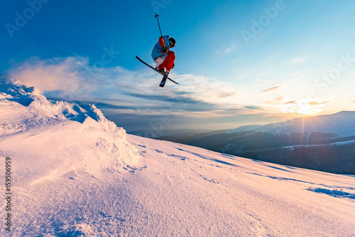 good skiing in the snowy mountains, Carpathians, Ukraine, a beautiful winter sunset, incredible ski jump
