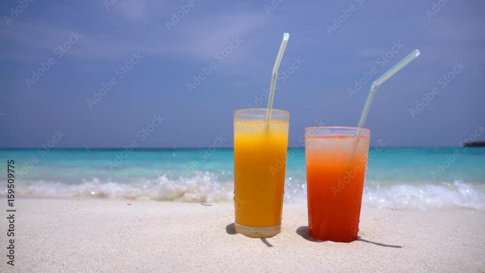 Two Cocktails in glass on white sandy beach with sea background. Travel destinations, nobody
Two Cocktails in glass on white sandy beach with sea background. Travel destinations, nobody