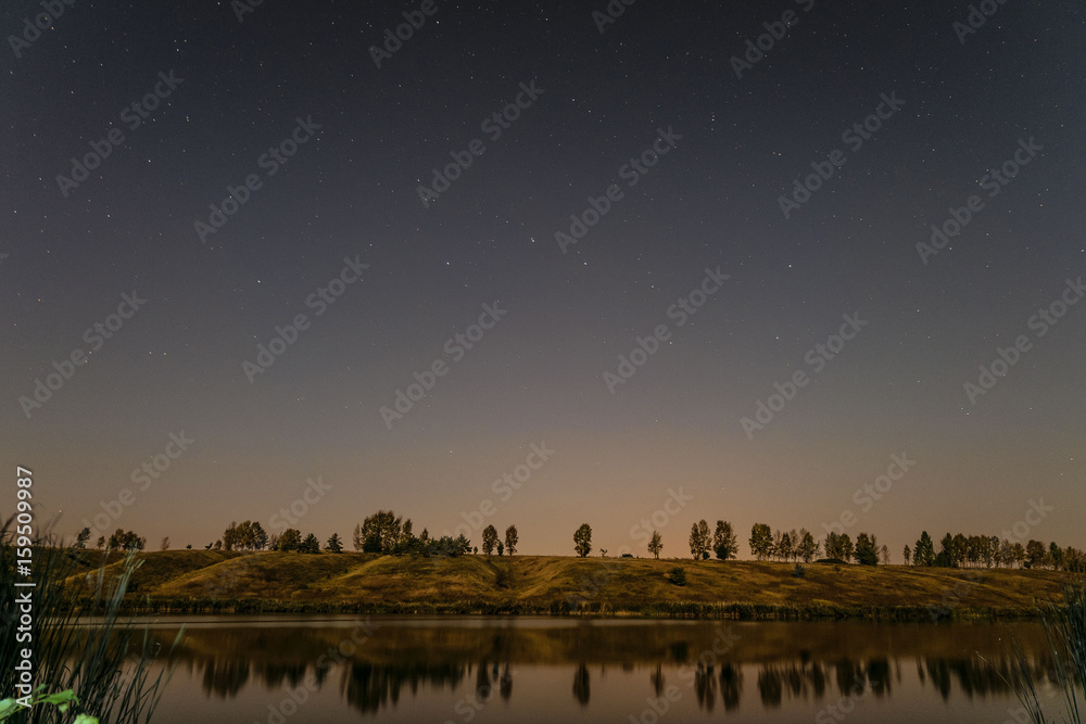 Obraz premium Starry night over the lake. Night landscape.