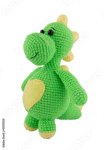 Soft knitted toy dragon isolated on white.