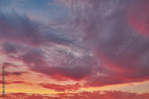 Beautiful clouds in the evening sky in the rays of the setting sun © Vladimir Kazimirov