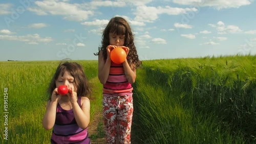 Children inflate balloons.