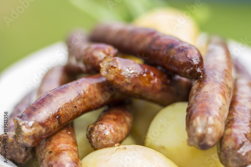 Grilled sausages with a boiled potatoes on a plate