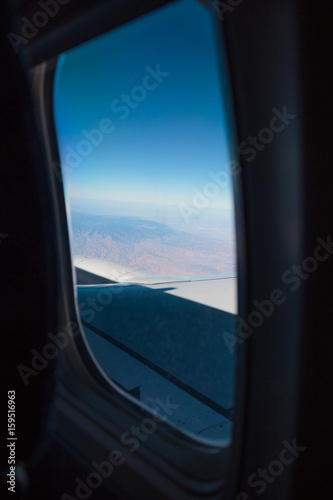 Photo of blue earth seen through airplane window