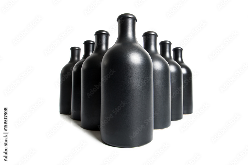 Matte black bottles on a white background close-up..