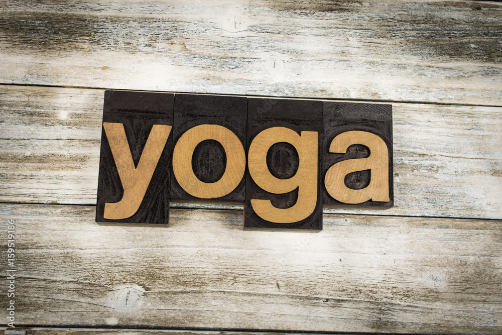 Fototapeta premium Yoga Letterpress Word on Wooden Background
