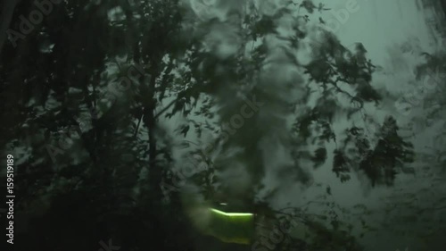 A strong hurricane outside the window, the lights go out in the apartment, the wind breaks the tree, strong wind and rain.
