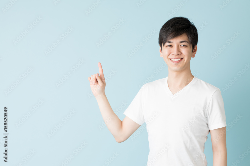 portrait of young asian man isolated on blue background portrait of young asian man isolated on blue background