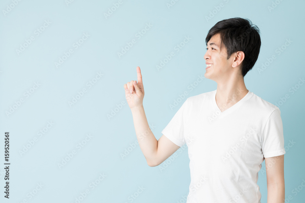 portrait of young asian man isolated on blue background portrait of young asian man isolated on blue background