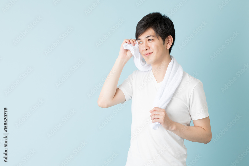 portrait of young asian man isolated on blue background portrait of young asian man isolated on blue background
