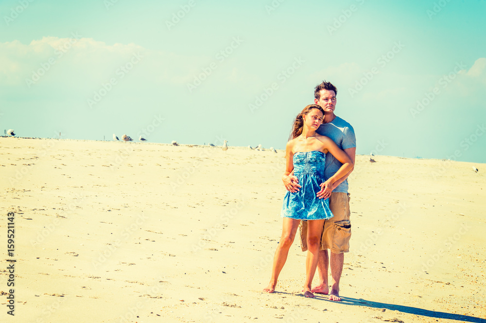 Young American Couple traveling, relaxing on the beach in New Jersey, USA