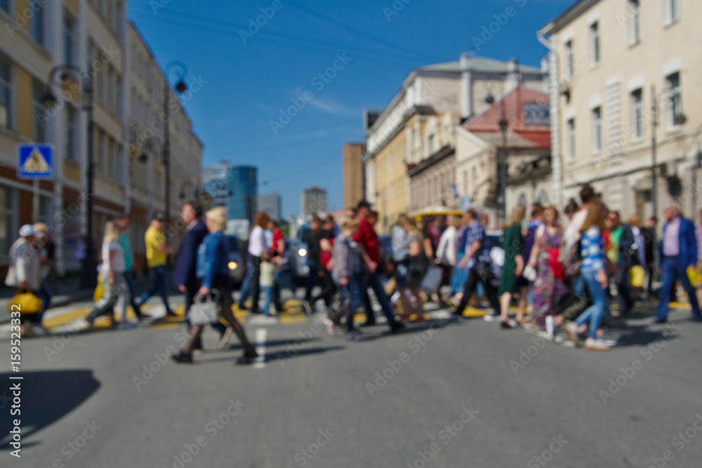 People walk on a pedestrian crossing, blurred background