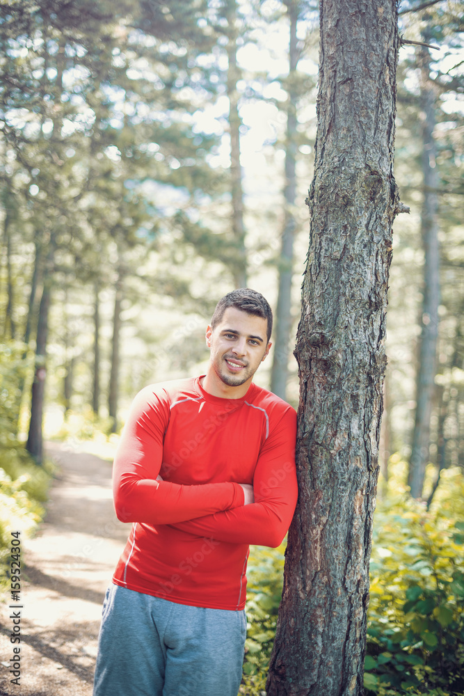 Sporty man posing in forest Sporty man posing in forest