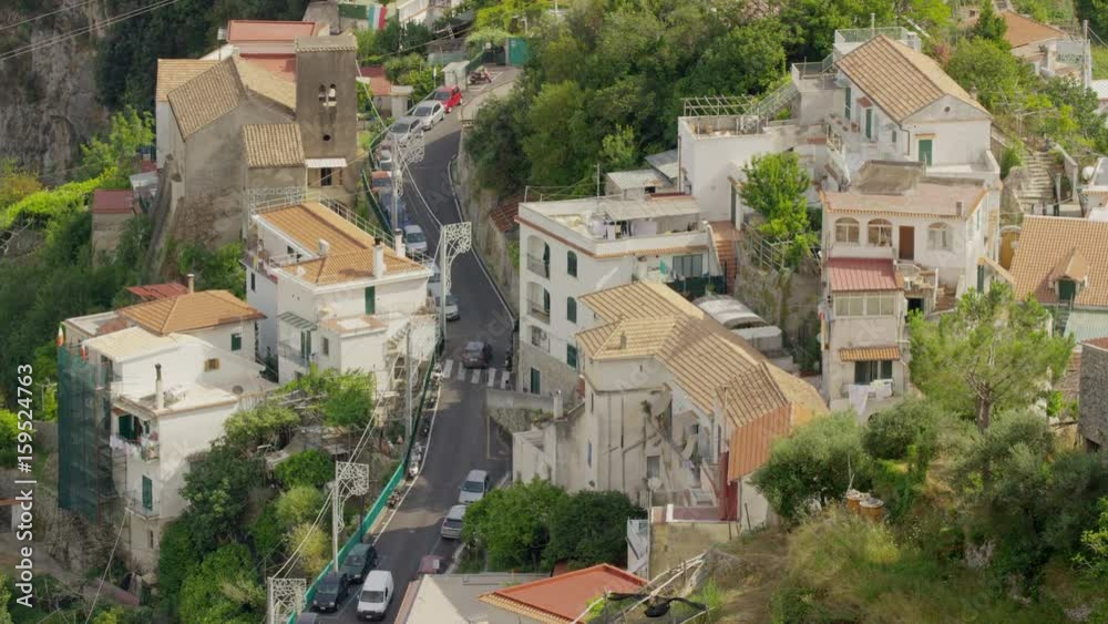 Wide high angle shot of cars driving on winding city street. Pontone, Campania, Italy Wide high angle shot of cars driving on winding city street. Pontone, Campania, Italy