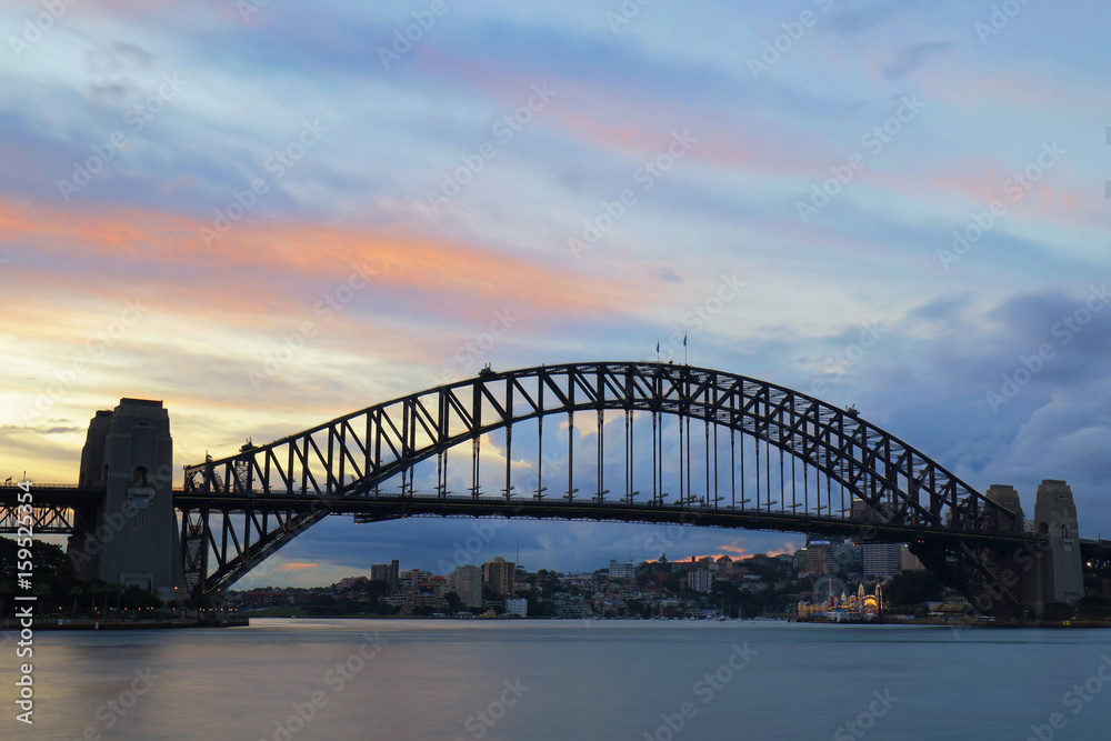 Sydney Harbour Bridge with streaks color of sunset