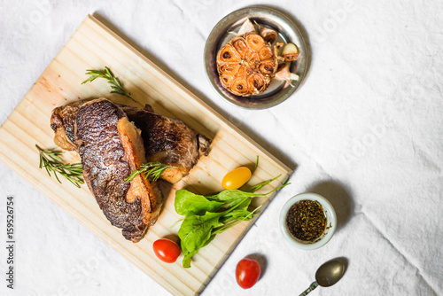 New york strip porterhouse steak meat with vegetables against white background
